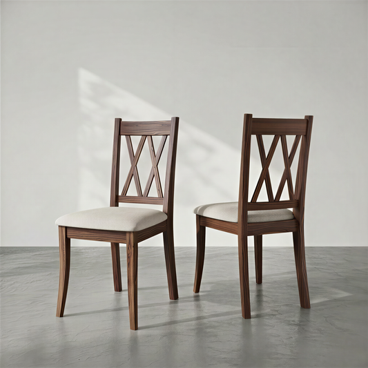Two wooden chairs with white cushions on a gray floor and light gray background