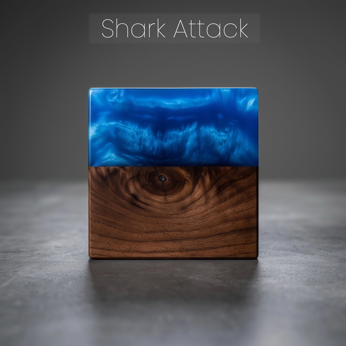 Square wood block with epoxy resin top on a gray surface