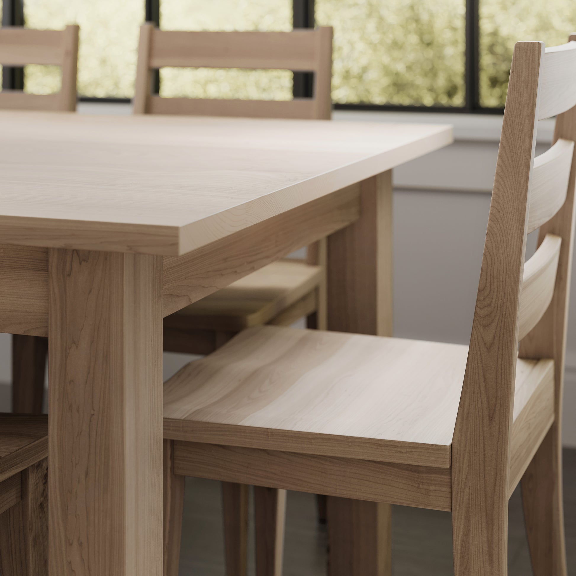 Close up image of a maple parson style dining table in a brightly lit dining room