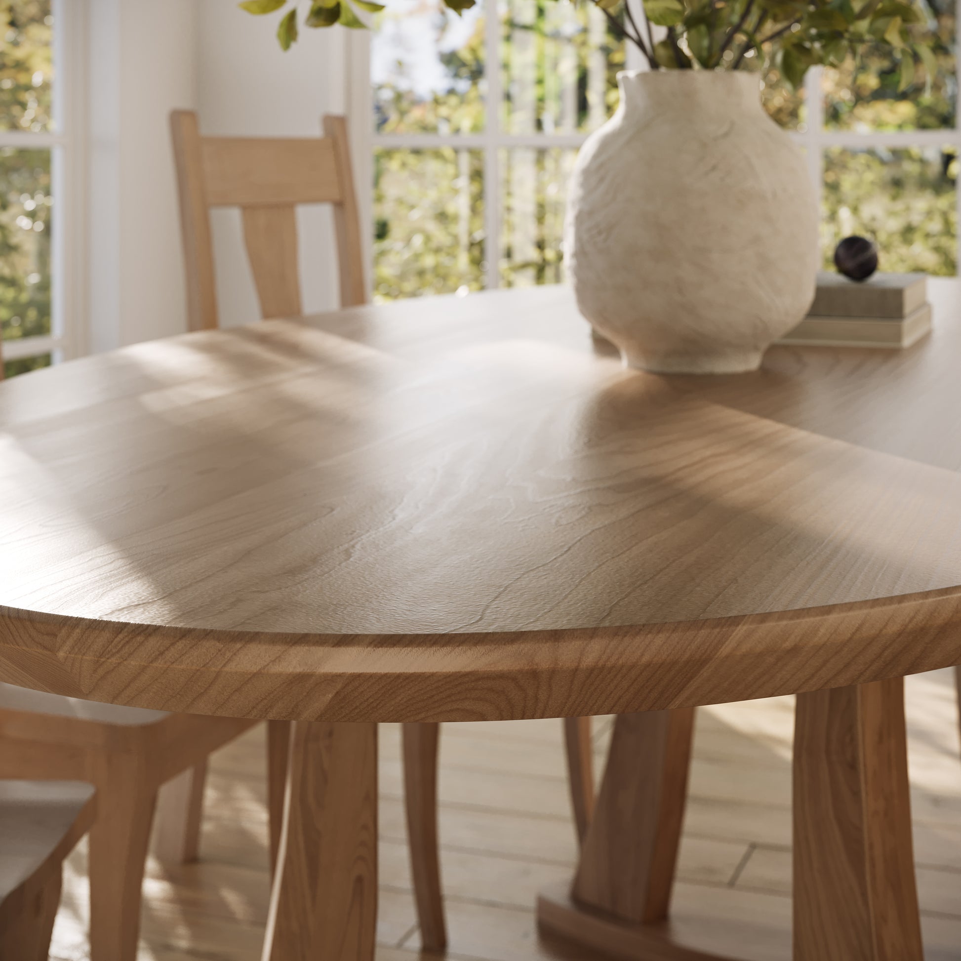 corner view of a maple oval dining table in a well lit dining room