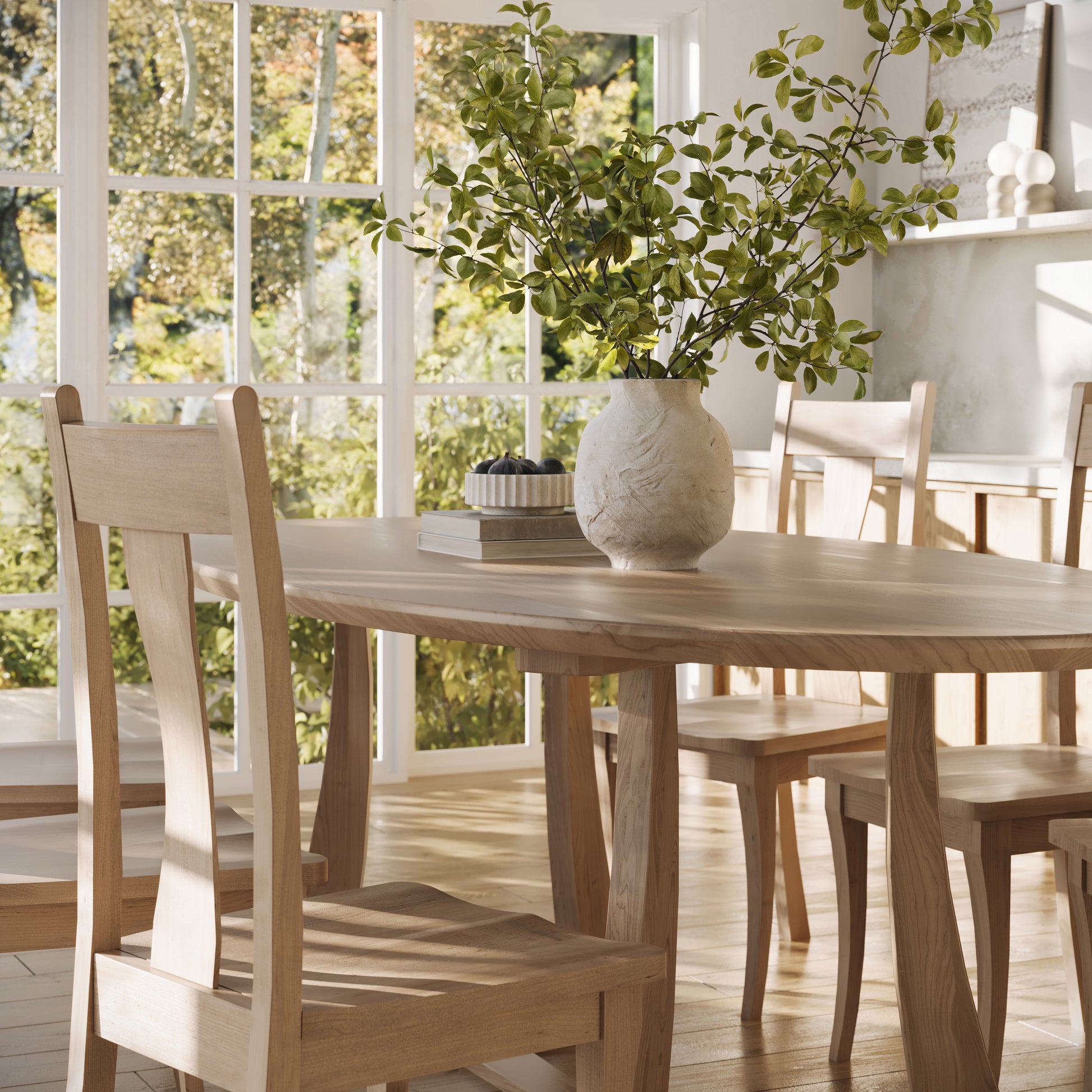 corner view of a maple oval dining table in a well lit dining room