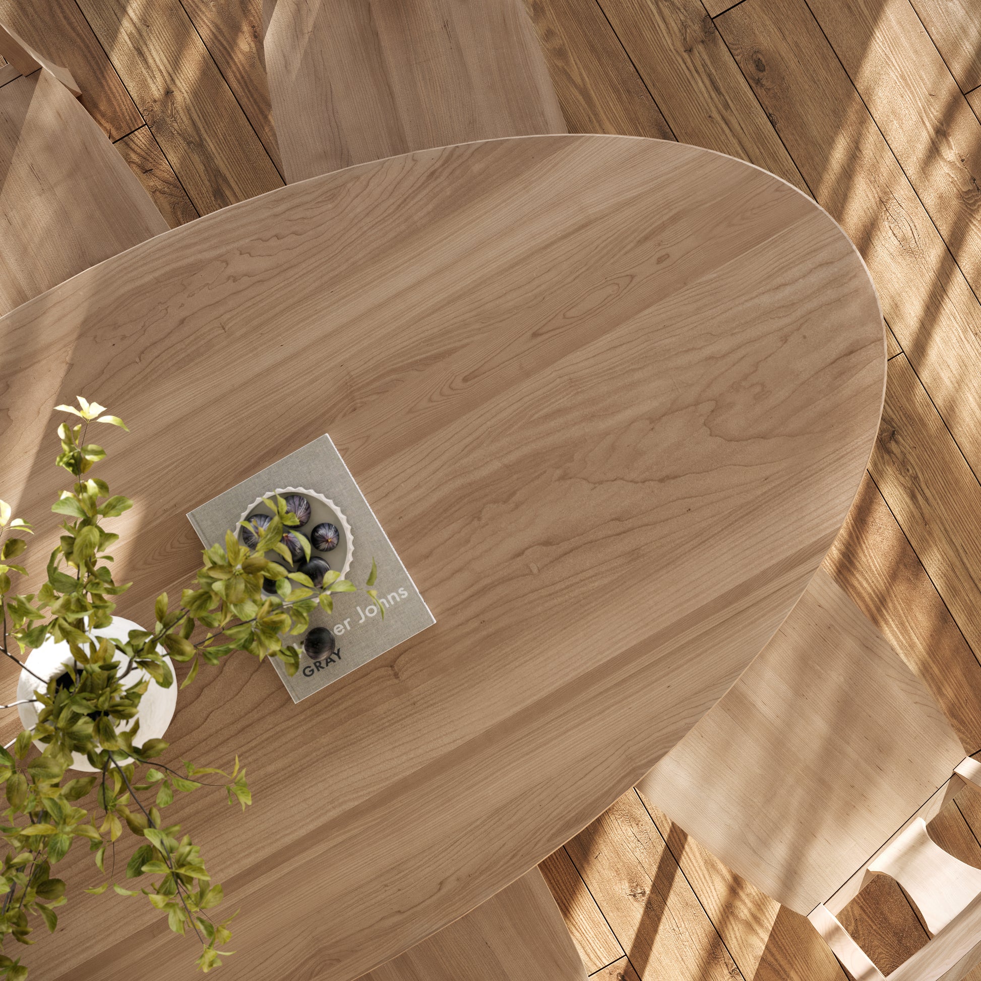 top down view of an oval maple dining table in a well lit dining room