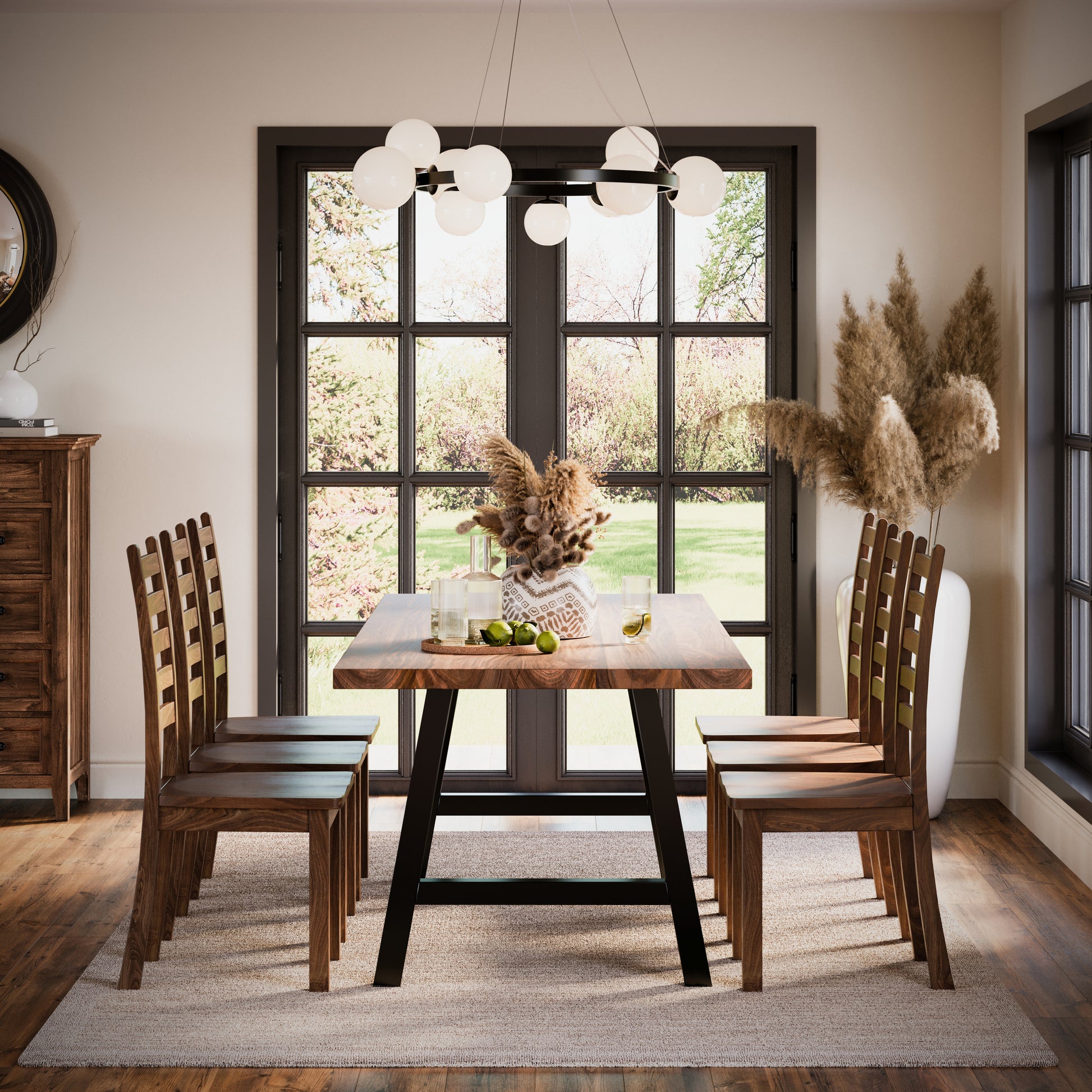 A rectangular dining table with a wood finish and metal legs, surrounded by matching chairs, placed in a room with large windows and a hanging light fixture.