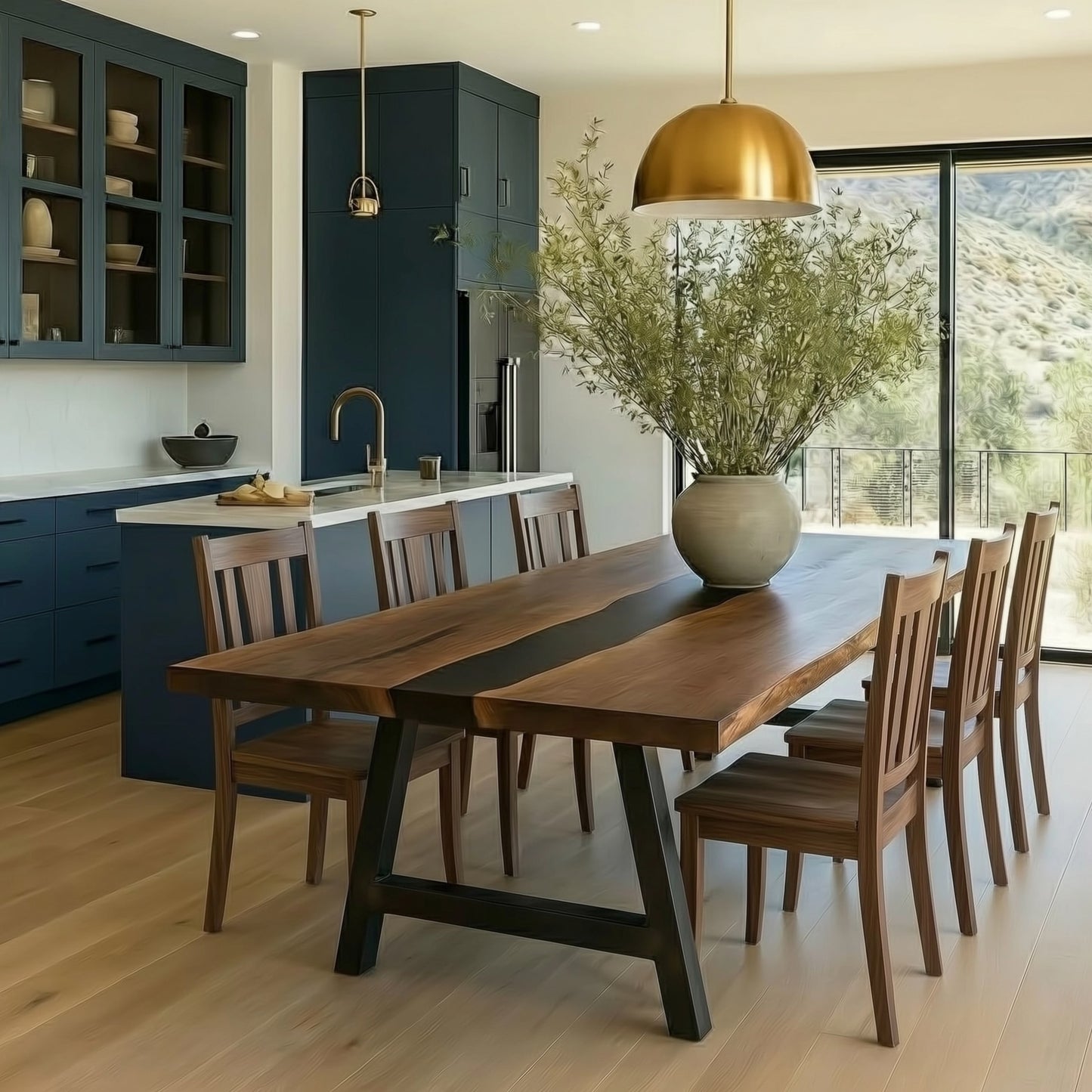 Modern kitchen with wooden dining table and chairs, gold pendant light, and large window.