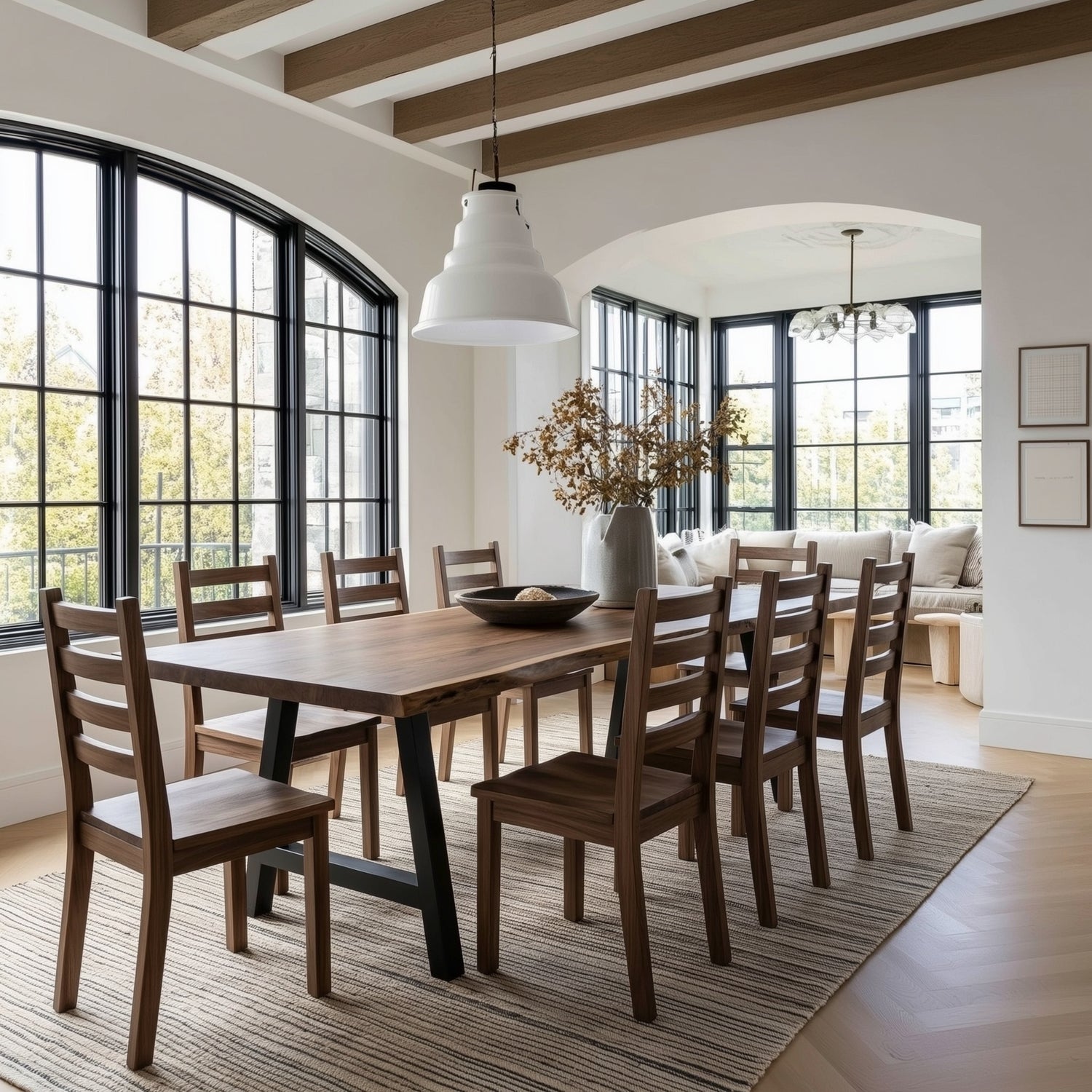 Modern dining room with wooden table and chairs, large windows, and a white ceiling light fixture.