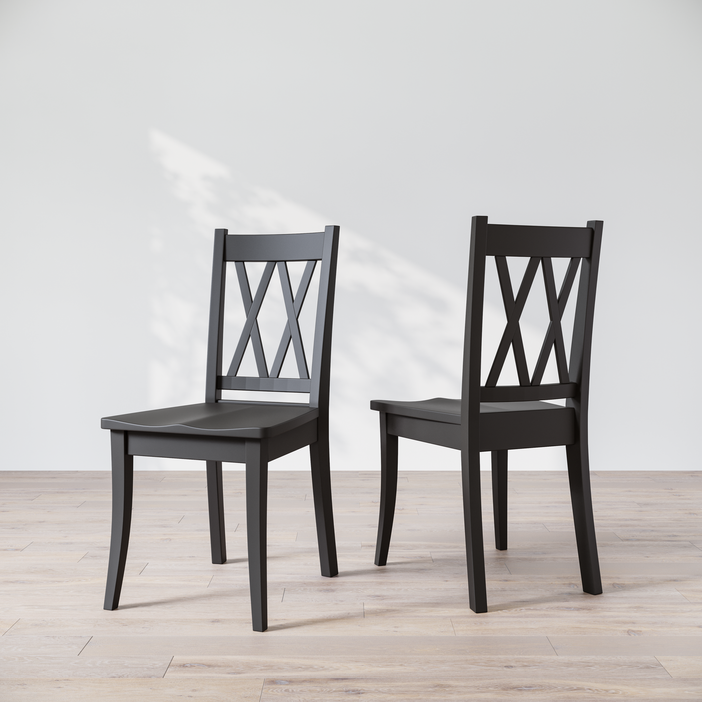 Two black wooden dining chairs with a 'Double X Back' design, placed against a neutral background.