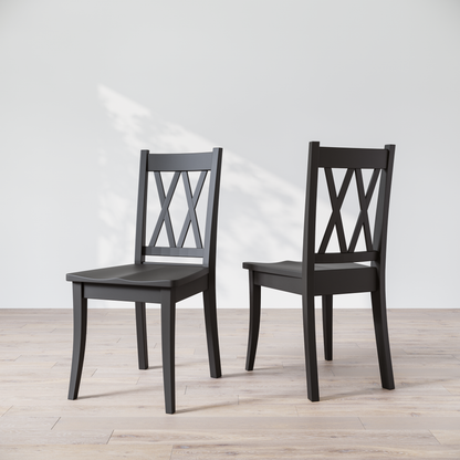 Two black wooden dining chairs with a 'Double X Back' design, placed against a neutral background.
