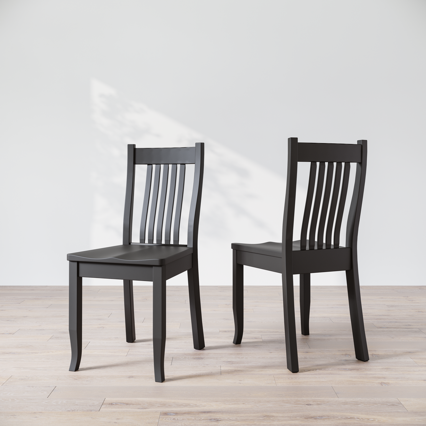 Two black wooden dining chairs, one facing forward and the other showing the side profile.