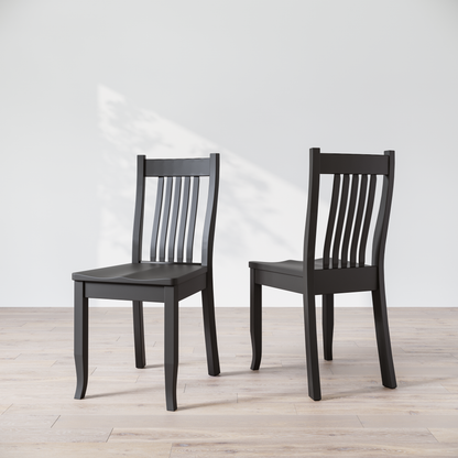 Two black wooden dining chairs, one facing forward and the other showing the side profile.