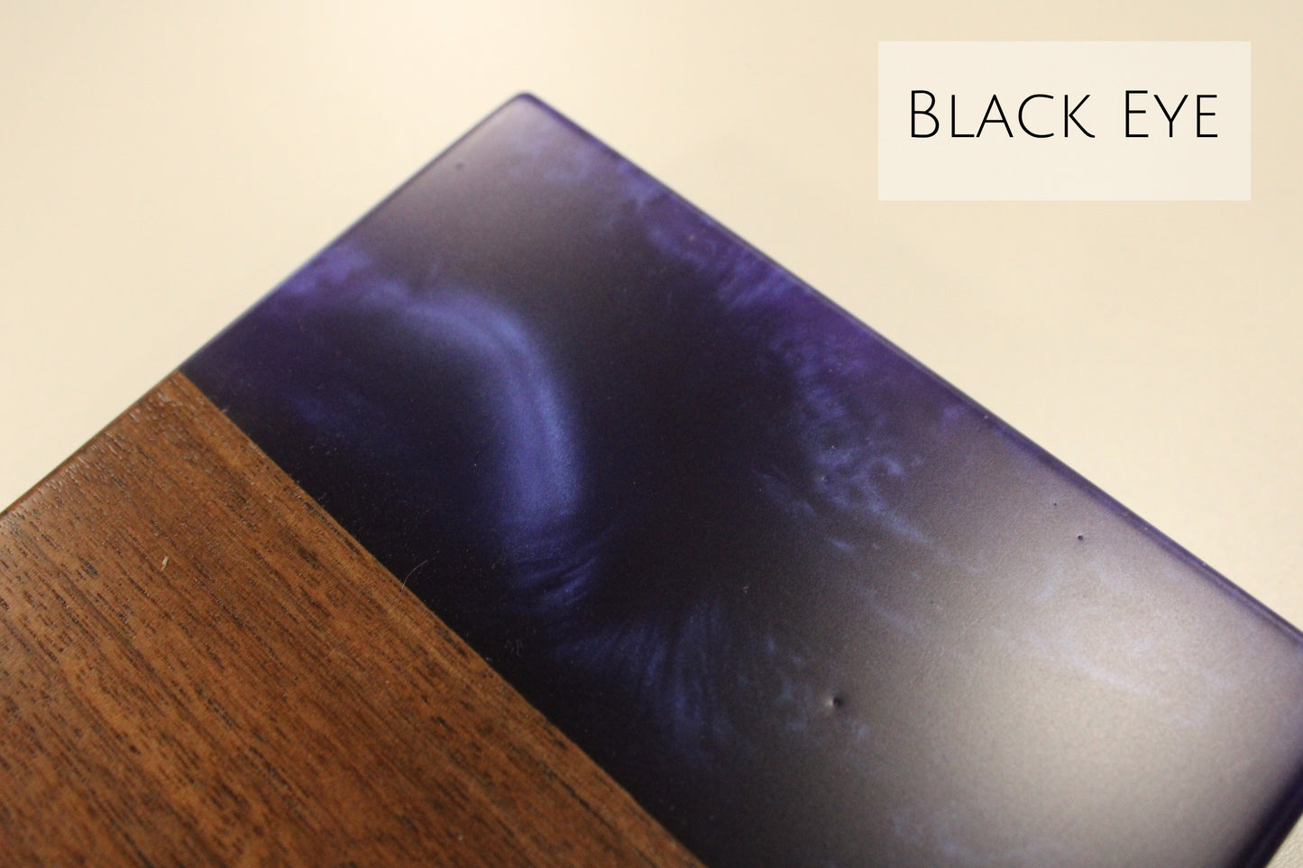 A close up of a walnut and dark blue epoxy sample