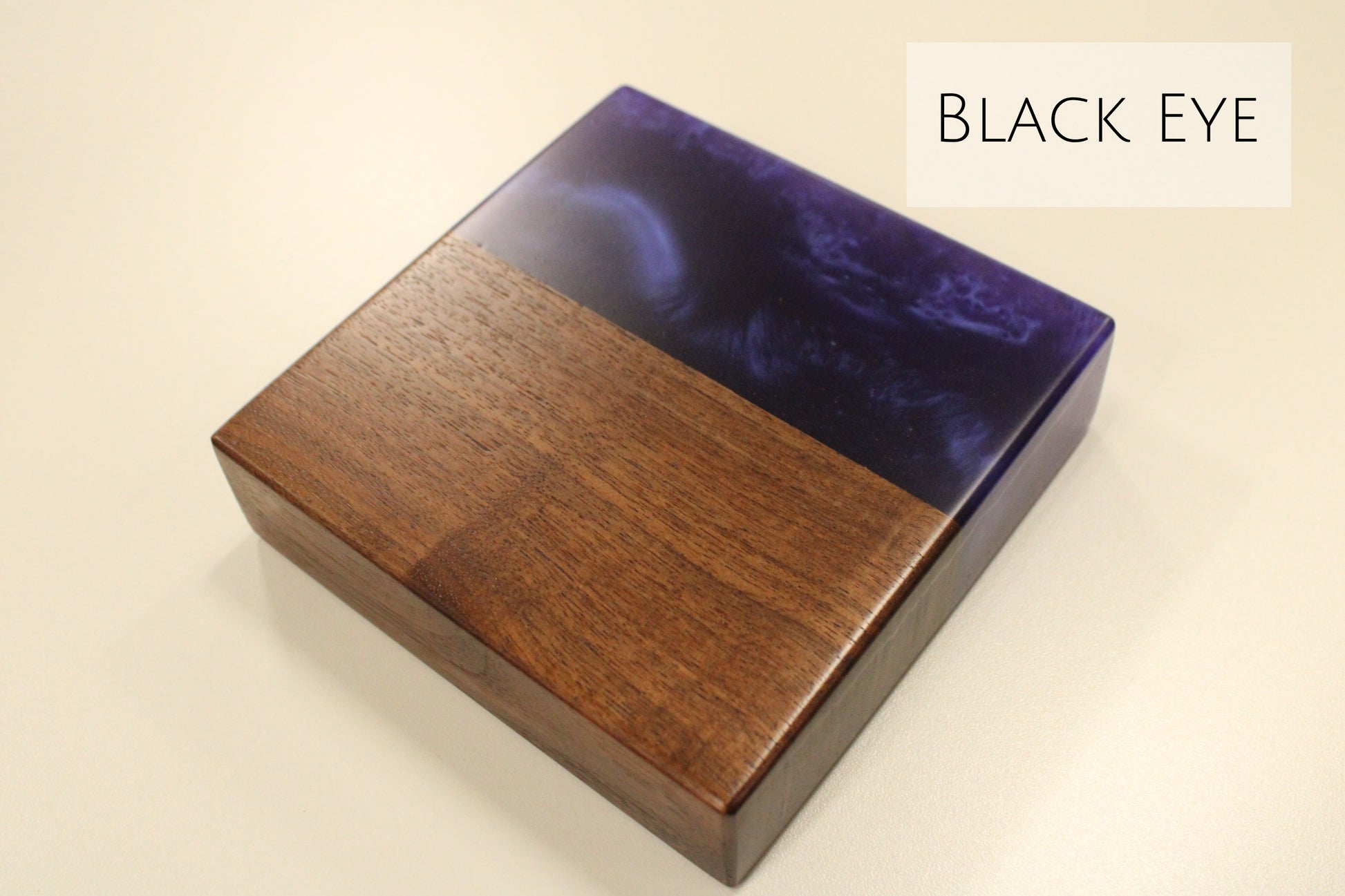 A walnut and dark blue epoxy sample