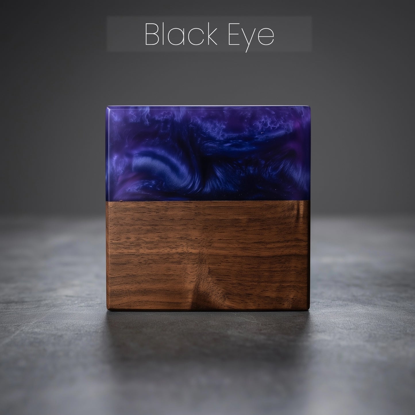 Square wood block with epoxy resin top on a gray surface