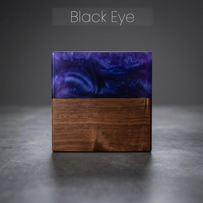 Square wood block with epoxy resin top on a gray surface