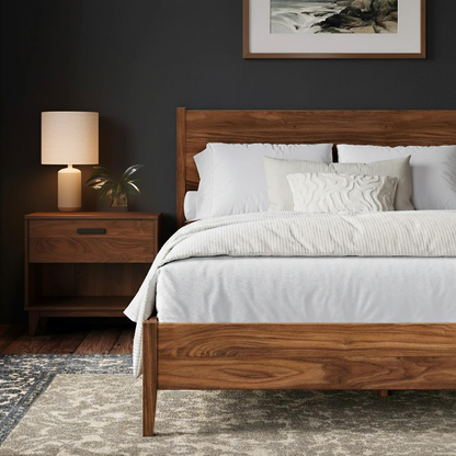 Wooden bed with white bedding in a bedroom setting with a side table and lamp.