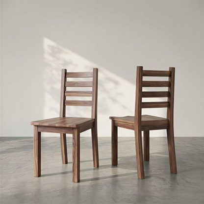 Two wooden chairs on a concrete floor with a light gray wall background