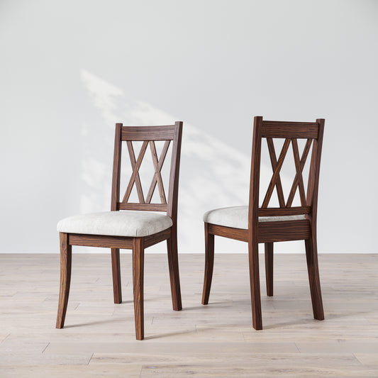 Two wooden dining chairs with a 'Double X Back' design and beige upholstered seats, placed against a neutral background.