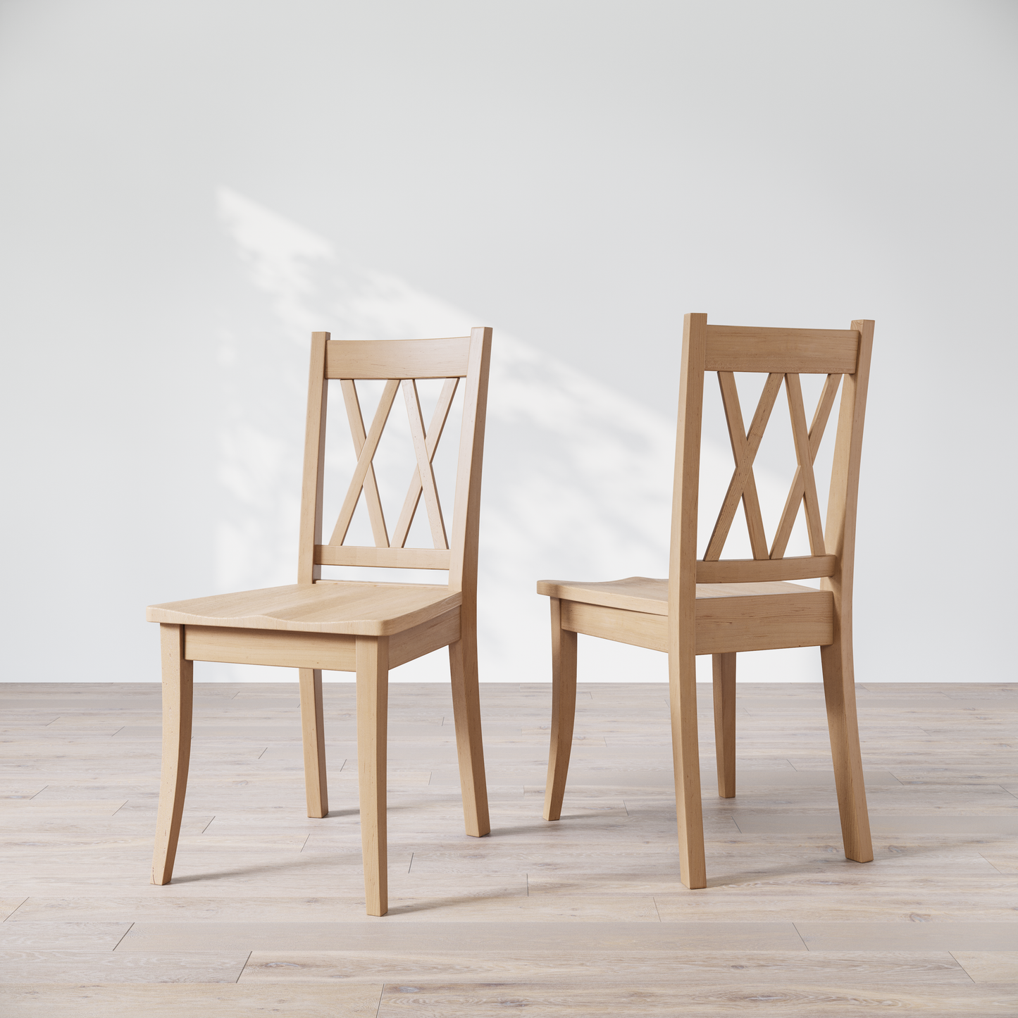 Two wooden dining chairs with a 'Double X Back' design, placed against a neutral background.