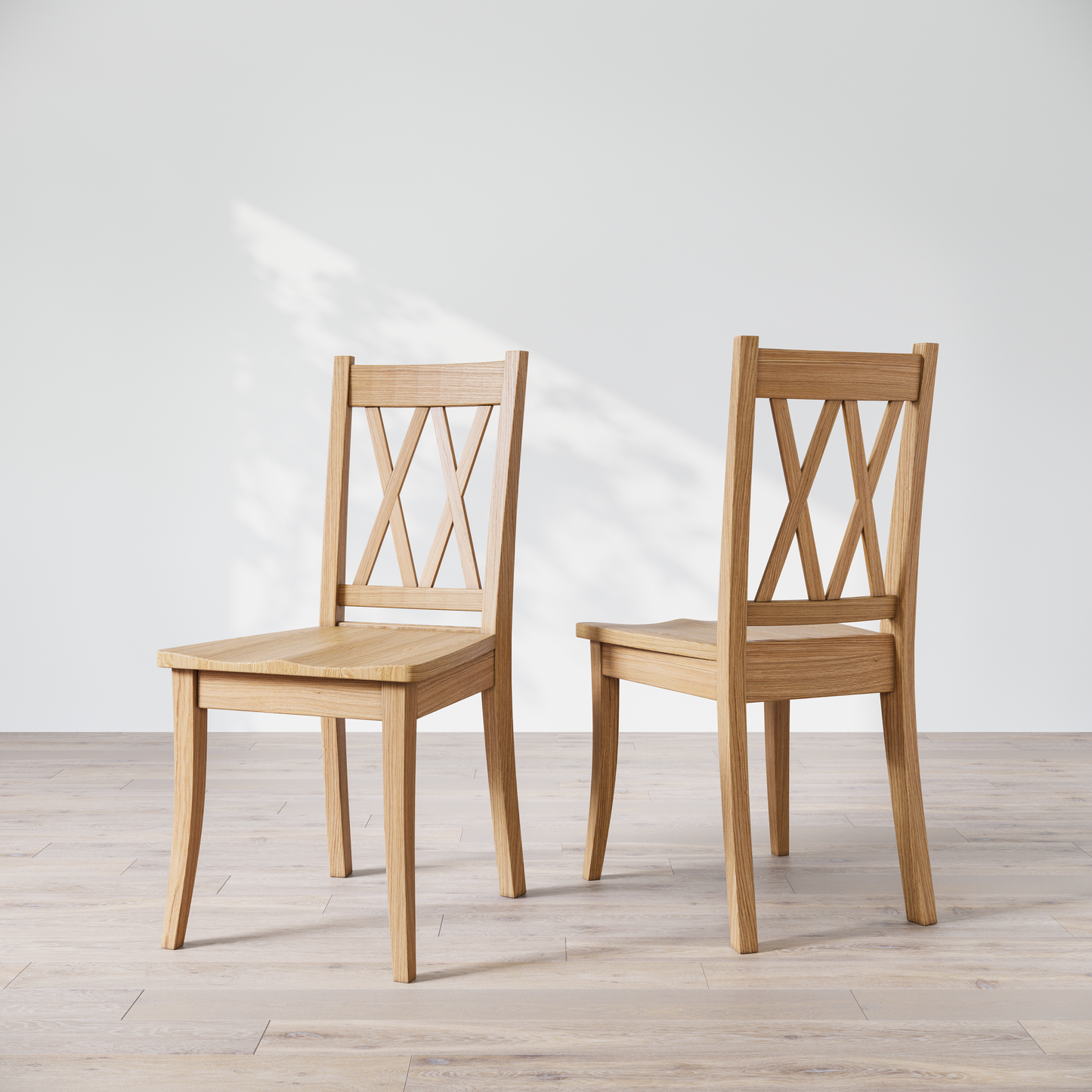 Two wooden dining chairs with a 'Double X Back' design, placed against a neutral background.