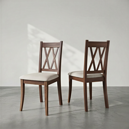 Two wooden chairs with white cushions on a gray floor and light gray background