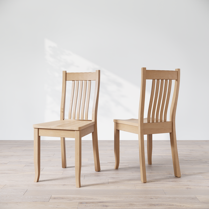 Two Maple wooden dining chairs, one facing forward and the other showing the side profile.