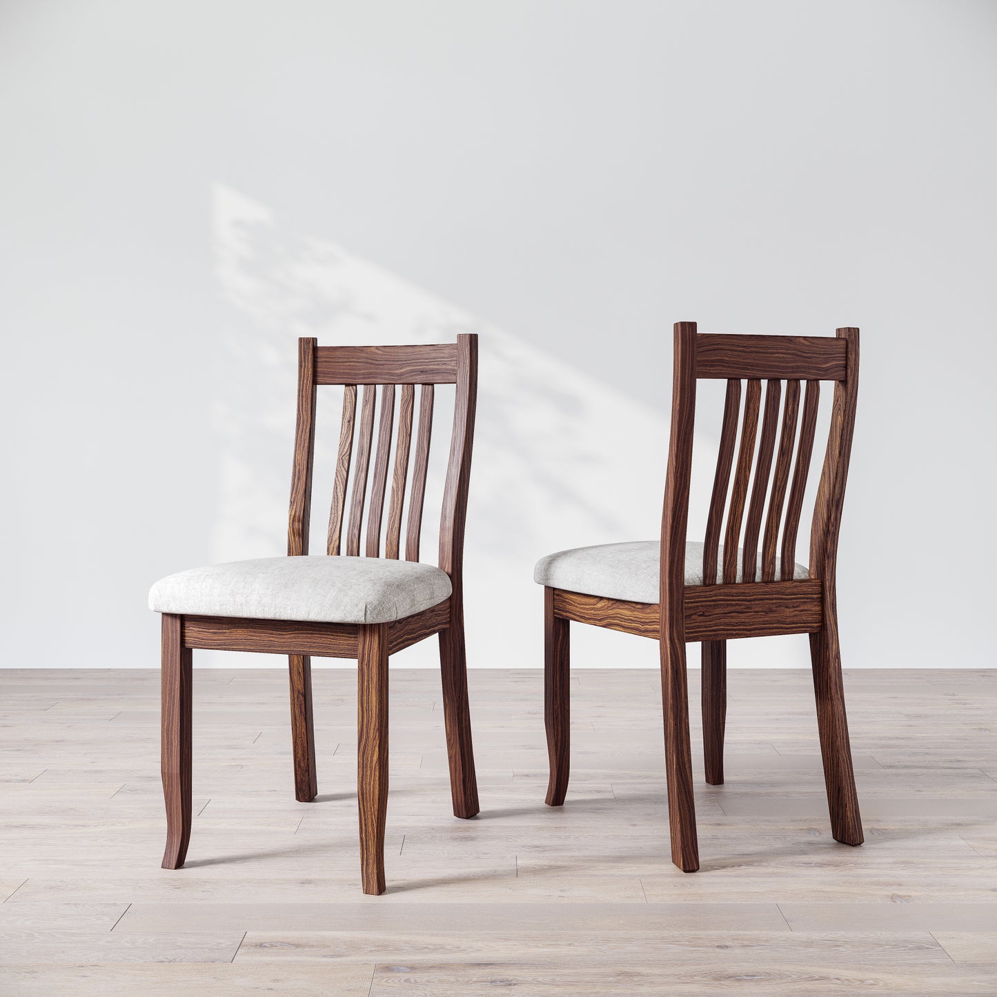 Two brown wooden dining chairs with upholstered seats, one facing forward and the other showing the side profile.