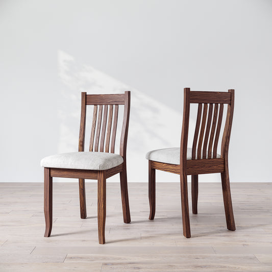 Two brown wooden dining chairs with upholstered seats, one facing forward and the other showing the side profile.