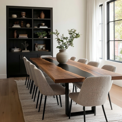 Dining room with a long wooden table and chairs, black bookshelf, and large window.