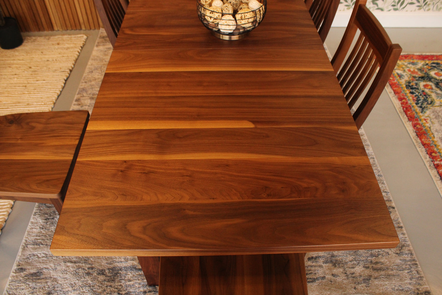 Wooden dining table with chairs in a room setting