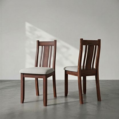 Two wooden chairs with white cushions on a gray floor and light gray wall.