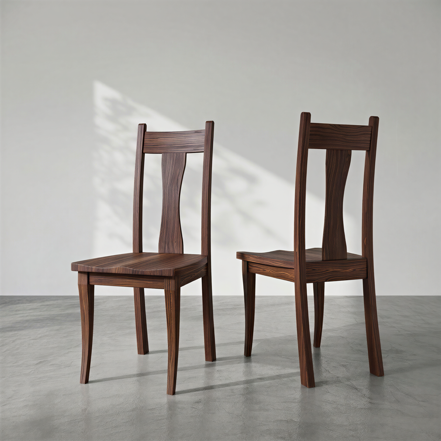 Two wooden chairs on a gray floor with a white wall background