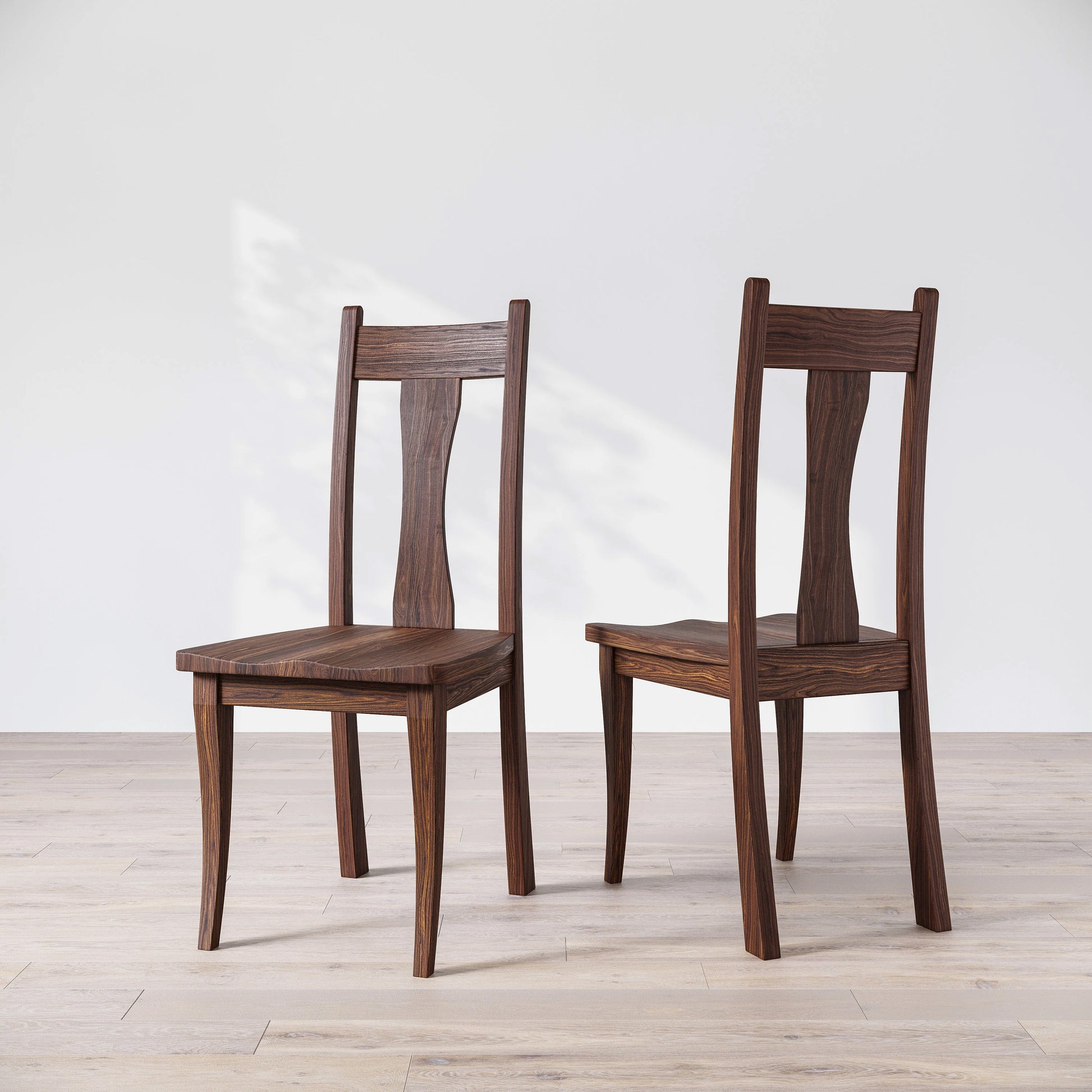 Two wooden chairs on a light wooden floor with a white background