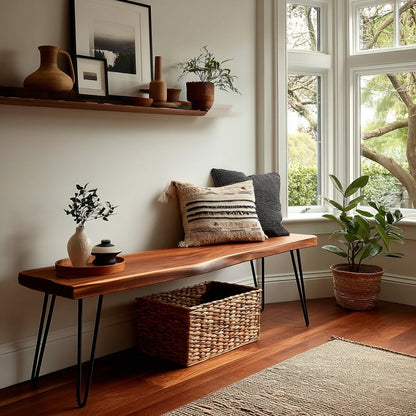 Wooden bench with pillows and a basket in a room with large windows and plants.