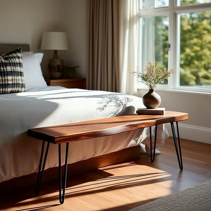 Wooden bench in front of a bed with natural light streaming through a window.