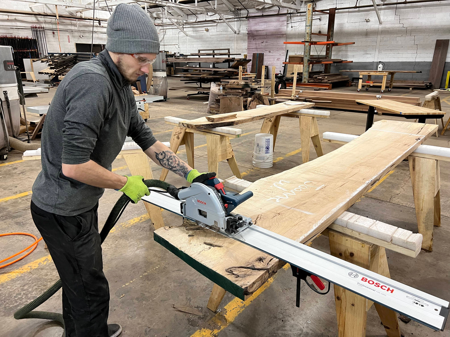 A craftsman cutting the end of a live edge slab
