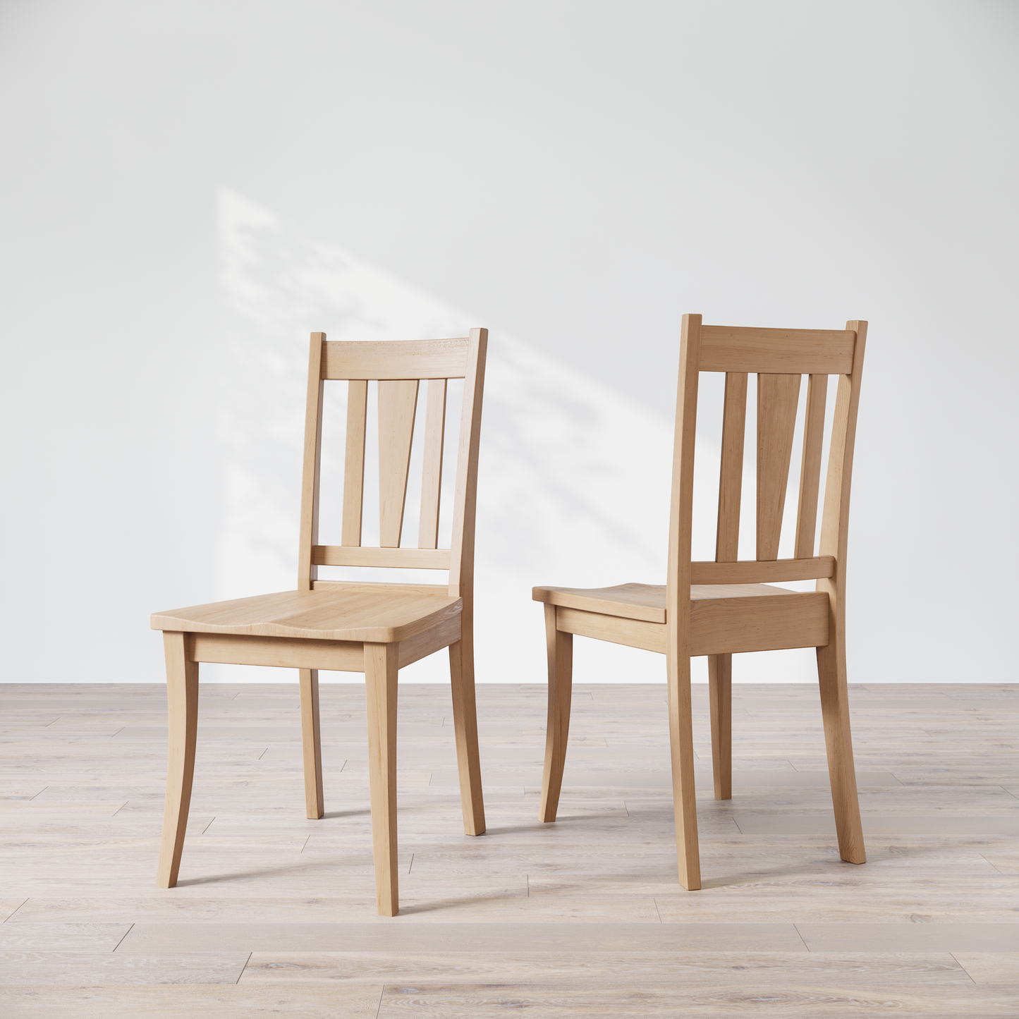 Two maple dining chairs with a brown finish, showcasing a slatted backrest and a solid seat, placed against a white background.