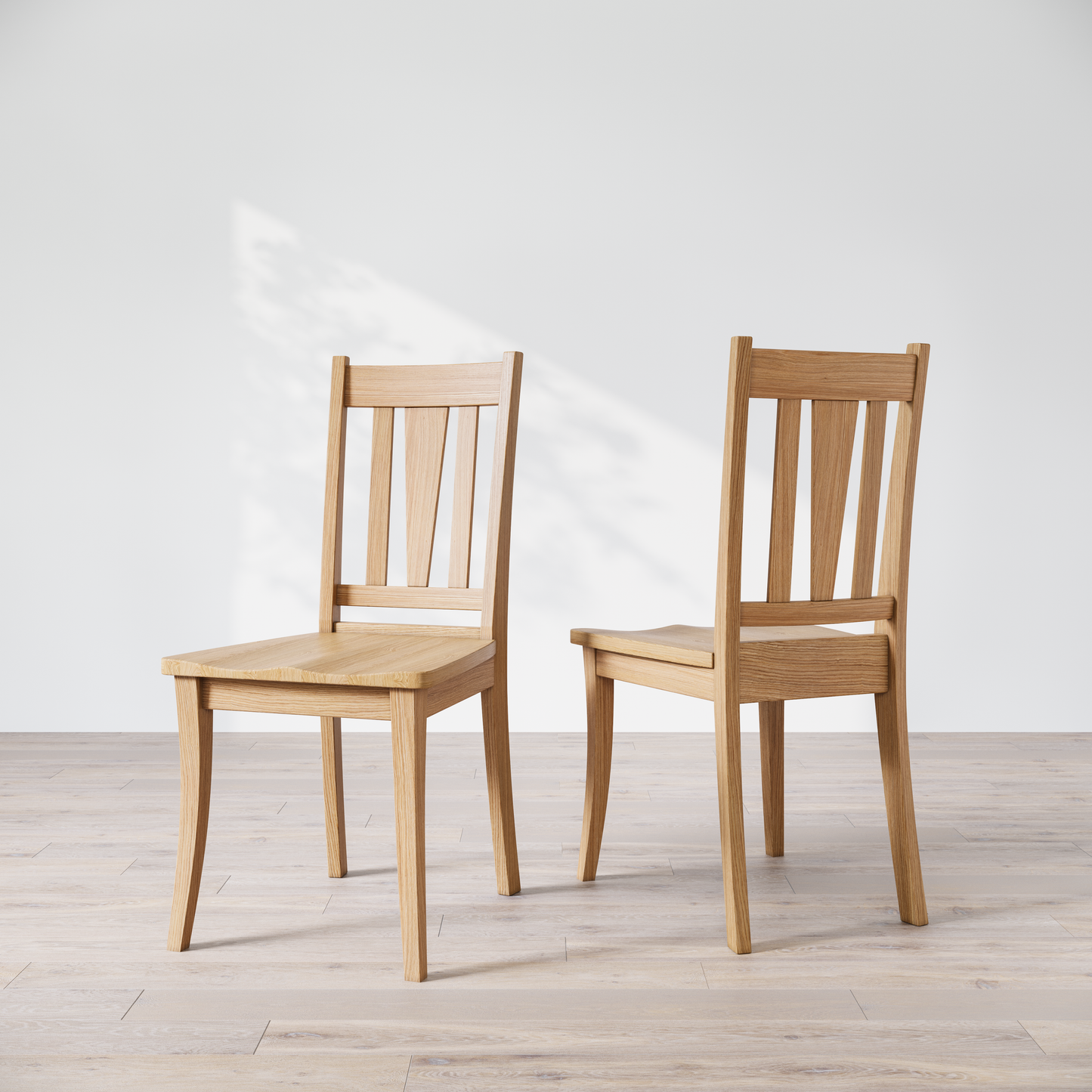 Two oak dining chairs with a brown finish, showcasing a slatted backrest and a solid seat, placed against a white background.