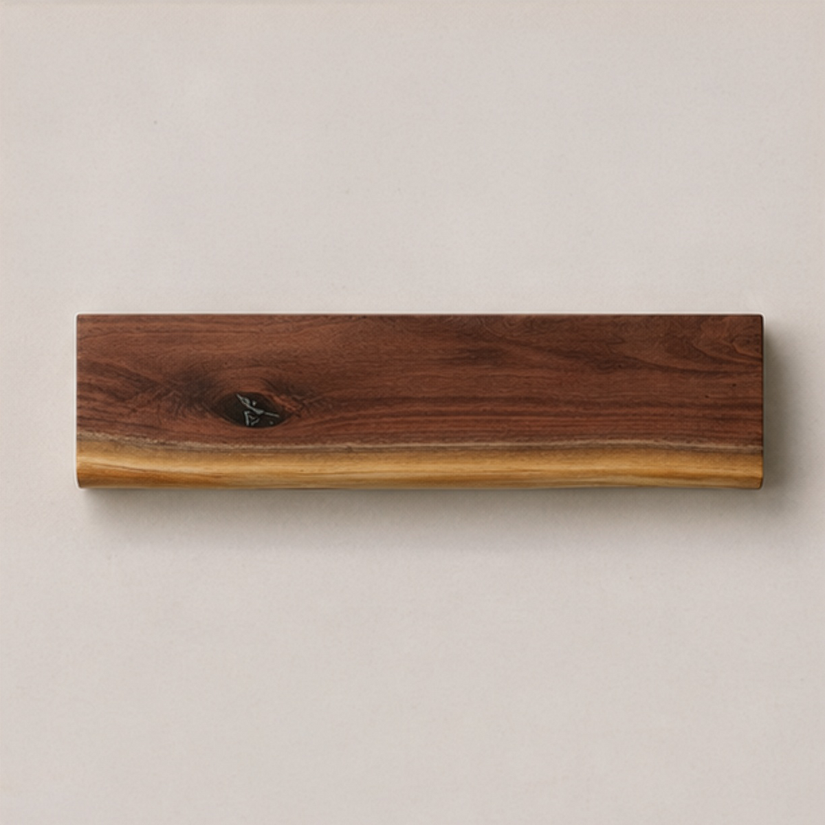 A rectangular live-edge wooden board with a rich dark brown wood grain and a natural light tan edge, displayed against a neutral light gray background.