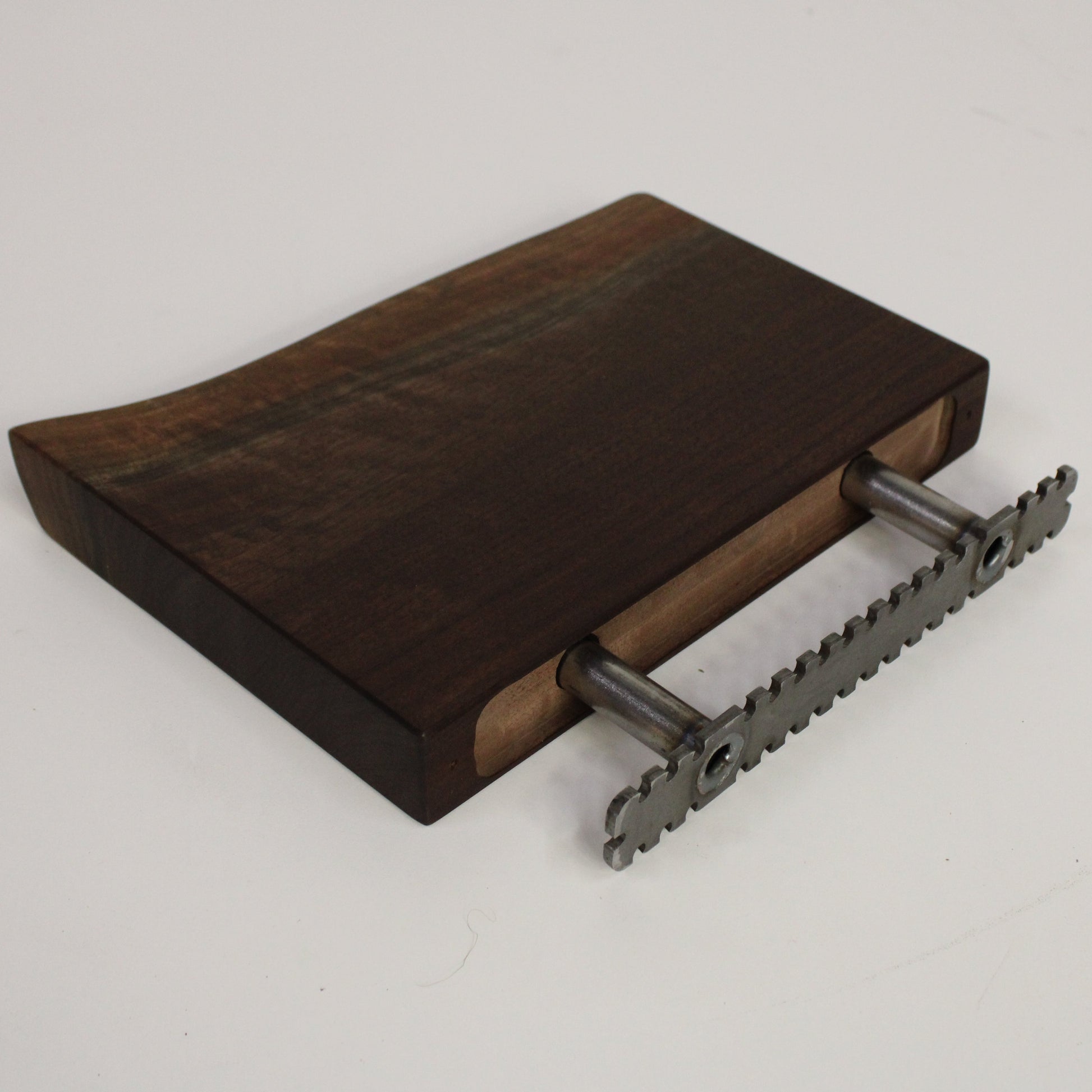 Wooden shelf with metal brackets on a light gray background