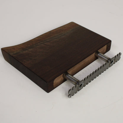 Wooden shelf with metal brackets on a light gray background