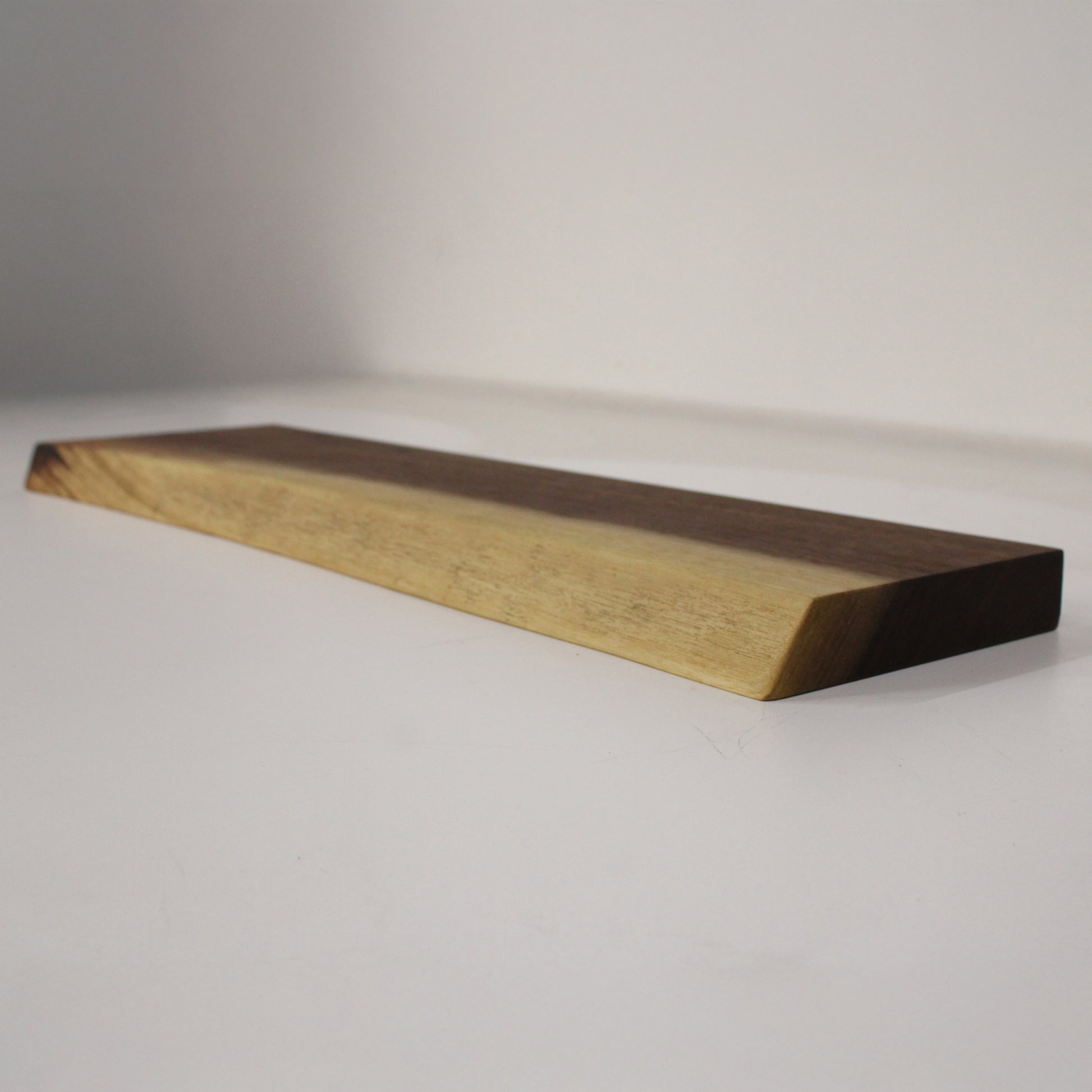 A live edge walnut shelf in a white space