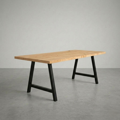 Wooden table with black metal legs on a gray floor and background