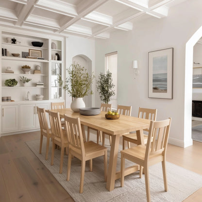 Dining room with wooden table and chairs, white walls, and decorative elements.