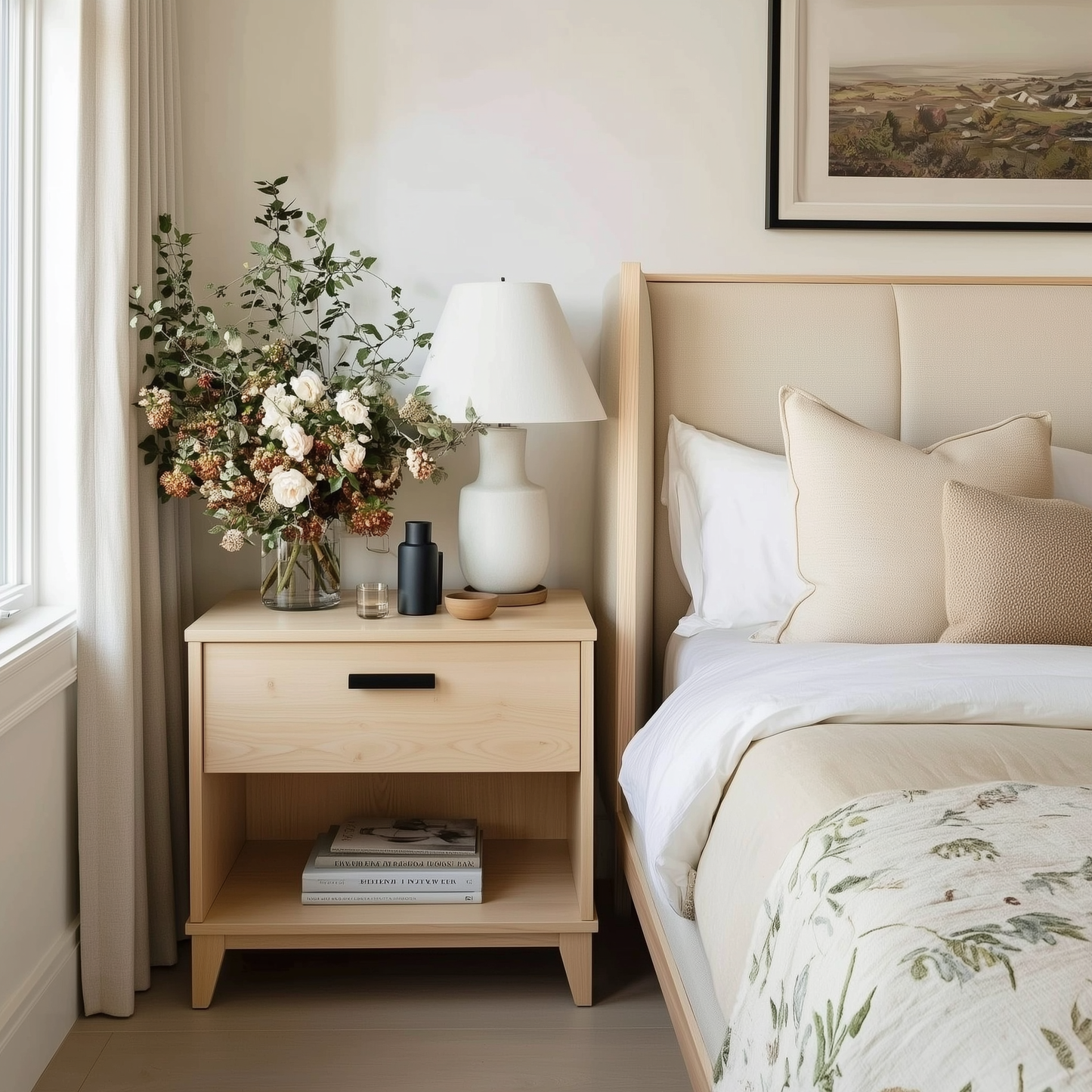 Neatly arranged bedroom with a bed, nightstand, and decorative elements.