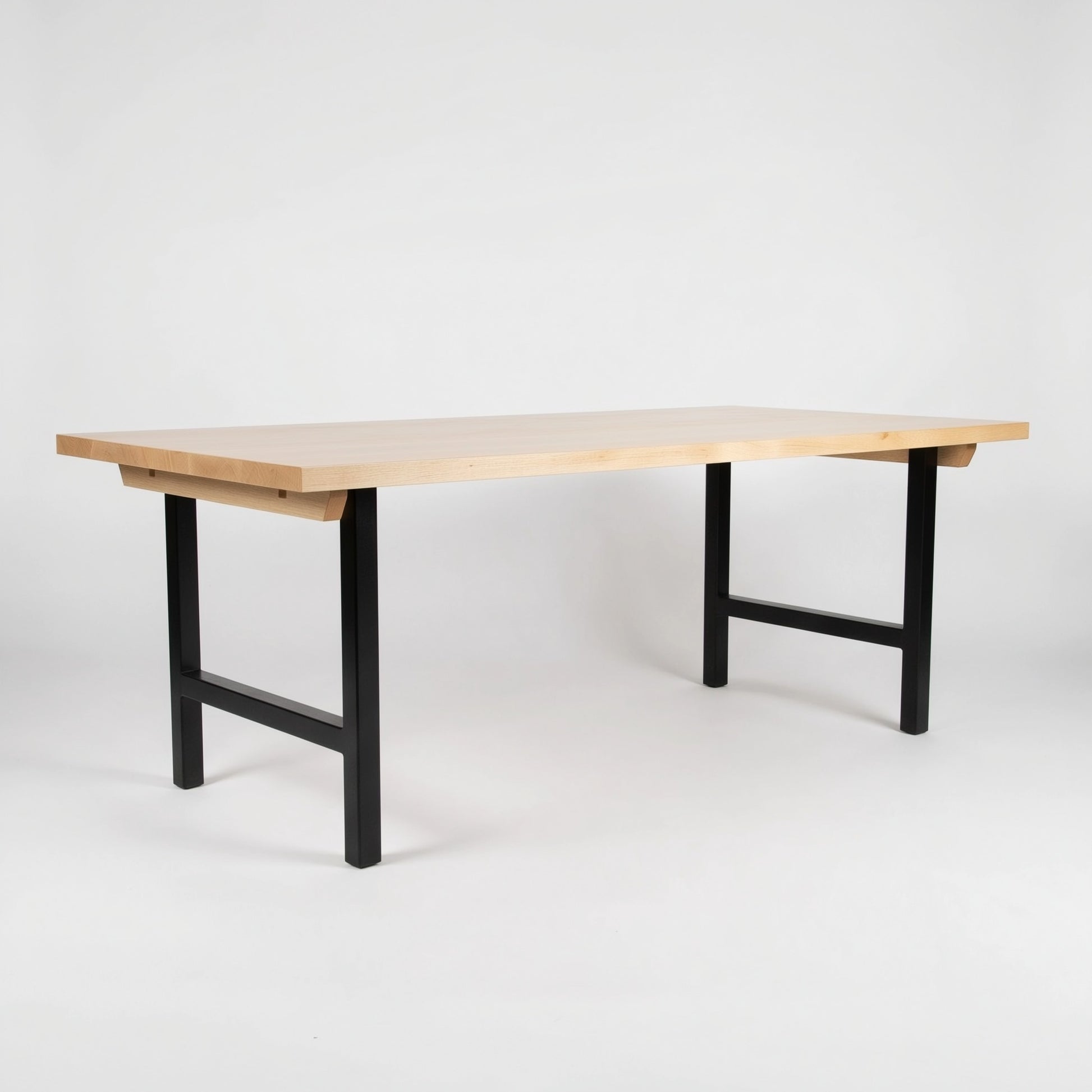 Wooden table with black legs on a white background