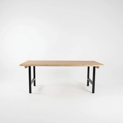 Wooden table with black legs on a white background
