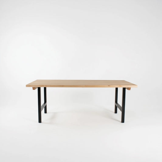 Wooden table with black legs on a white background
