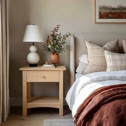 Nursery room with wooden nightstand, lamp, and decorative items.