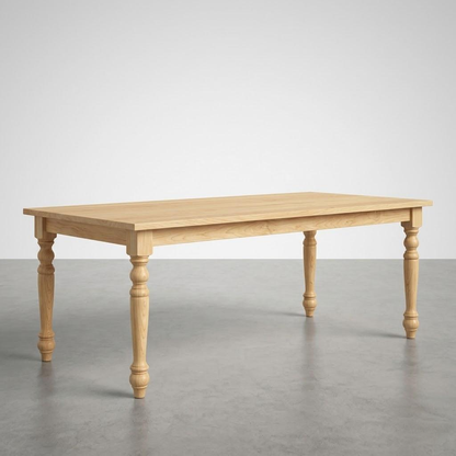 Wooden table with turned legs on a gray floor and white wall background