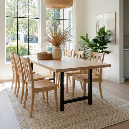 Dining room with wooden table and chairs, large windows, and decorative elements.