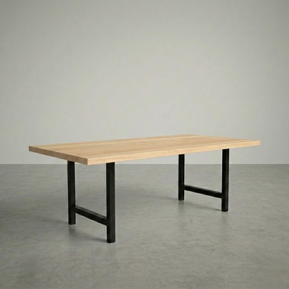 Wooden table with black metal legs on a gray floor and background